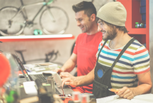 Two bicycle repairer colleagues working in bike garage