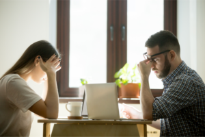 millennial businessman and businesswoman feeling confused and frustrated in office